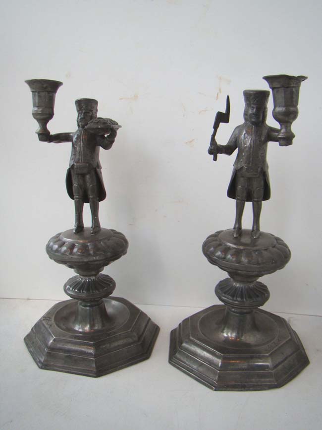 A nice pair of early 18th century Dutch pewter candlesticks depicting a Butcher and a Baker